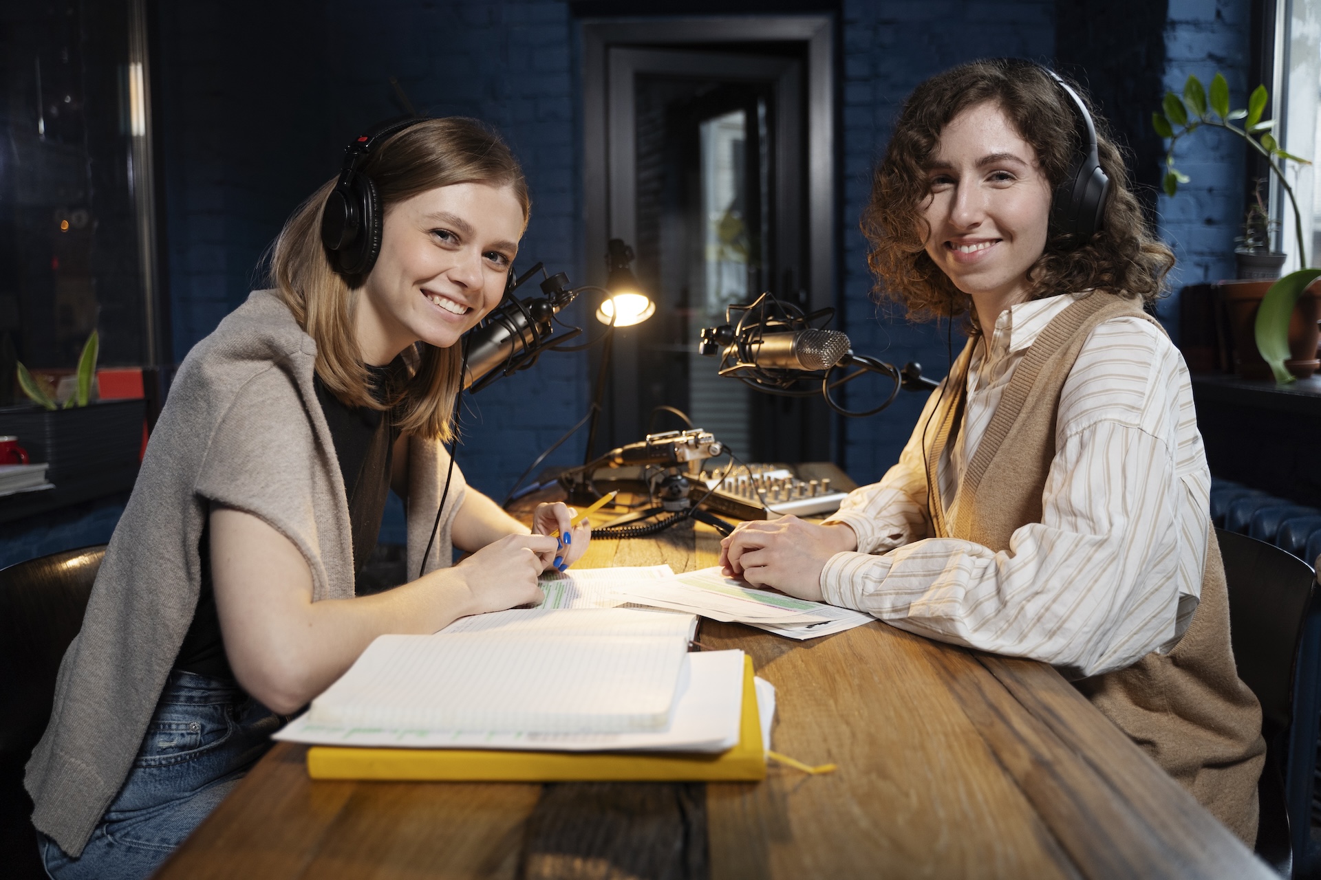 Zwei Frauen lächeln im Podcast Studio